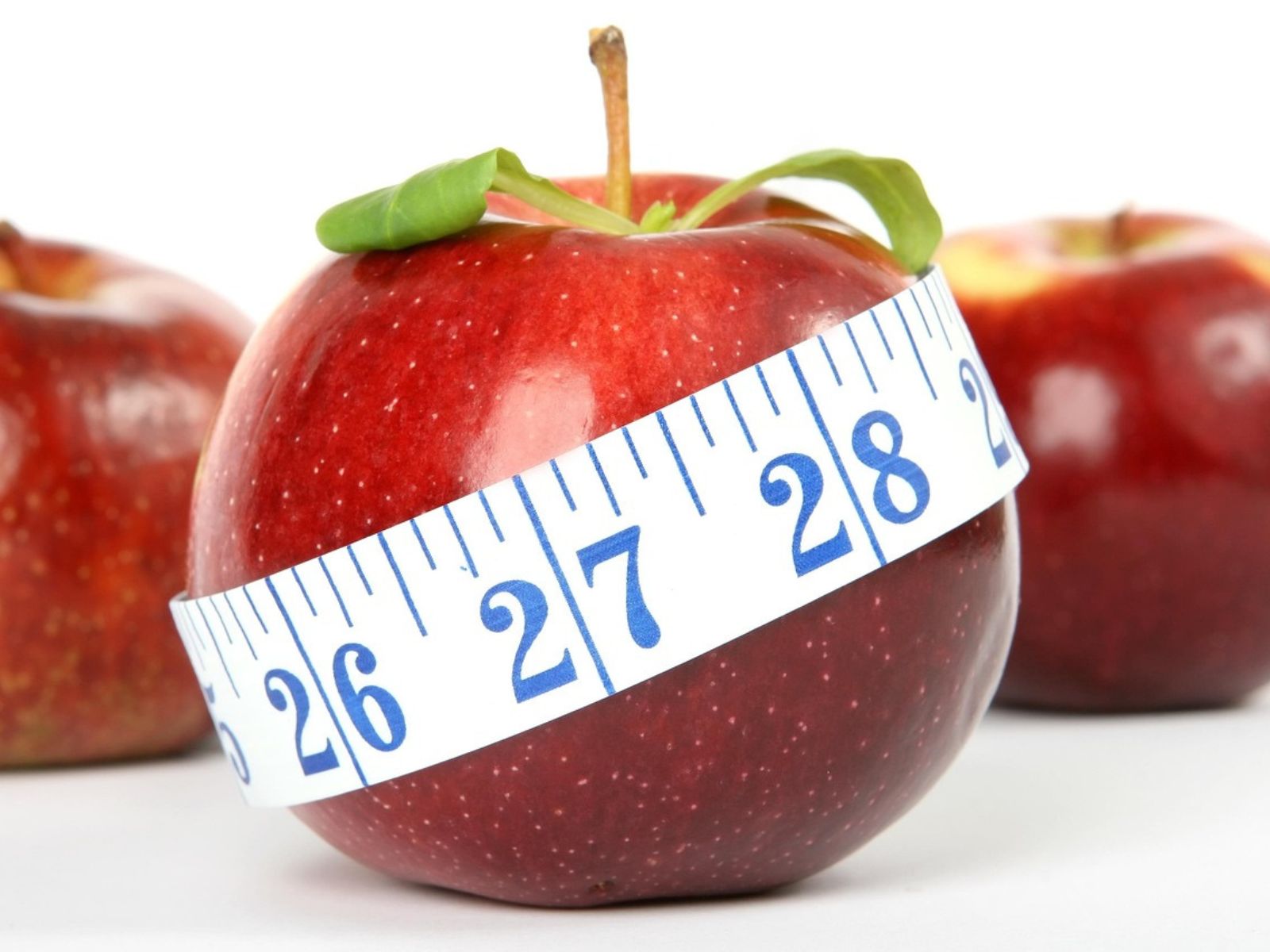 apple and tape measurer ruler inches